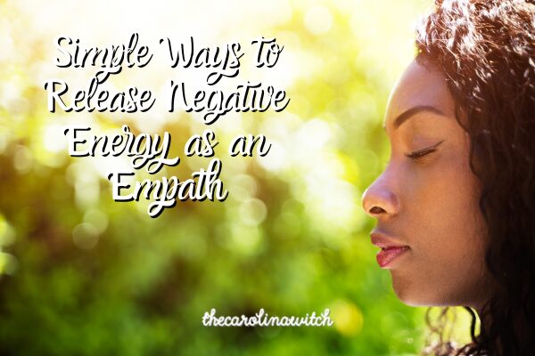 simple ways to release negative energy blog post title with a woman standing out in nature with her eyes closed.